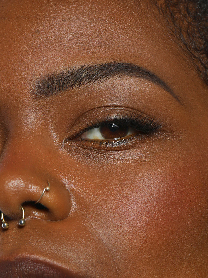 CLOSE UP OF MODEL WEARING BROW COLLECTION IN DARK
